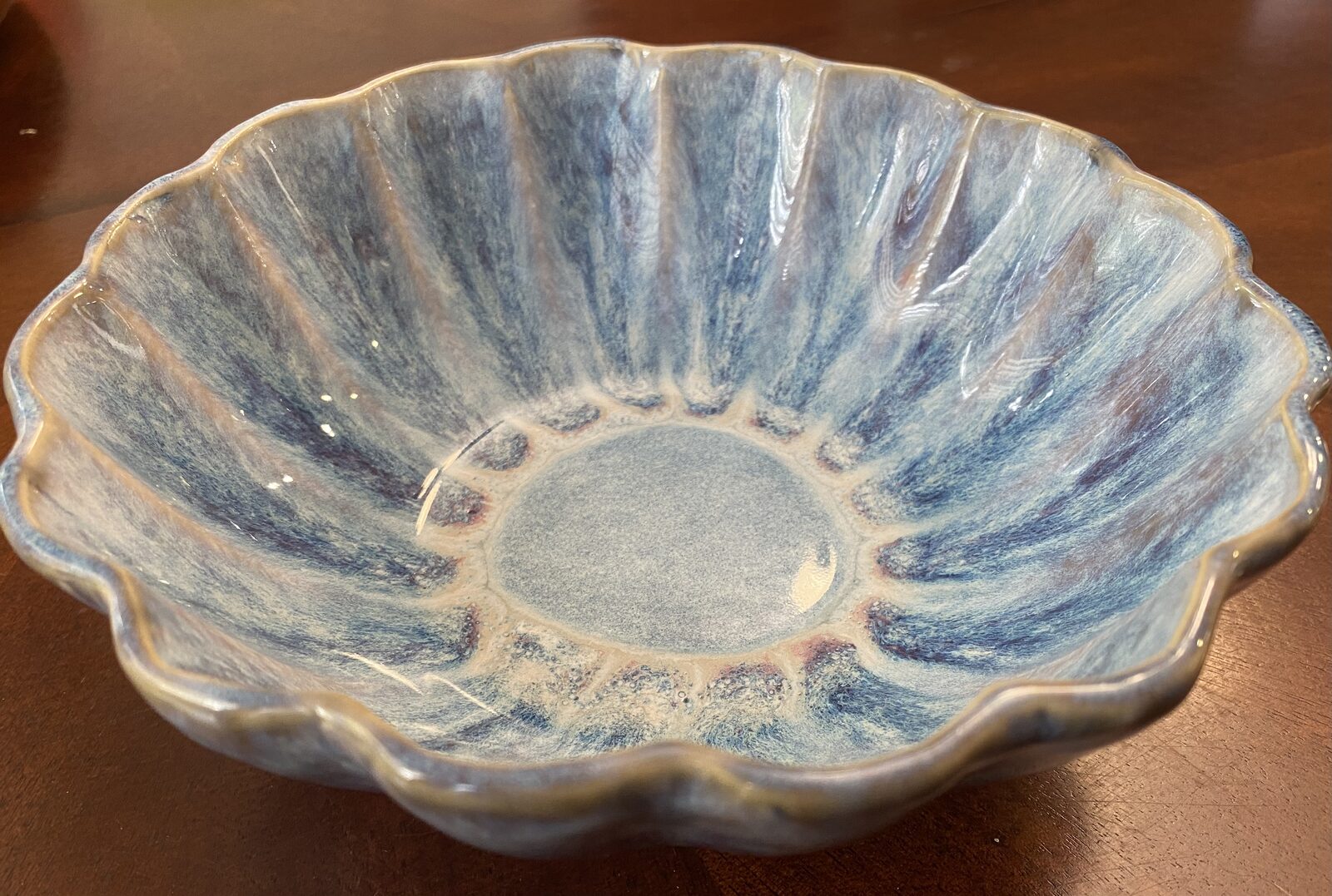 Scalloped flower-shaped serving bowl with soft blue glaze and feathered streaks