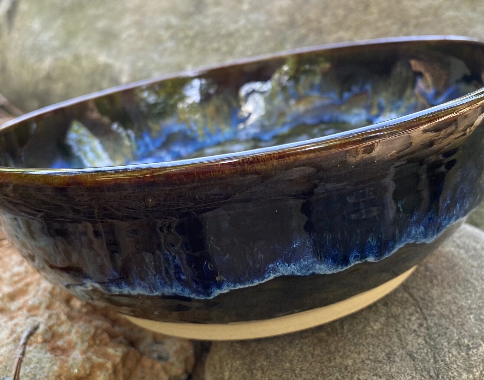 Large bowl with deep sapphire blue and amber drip glaze