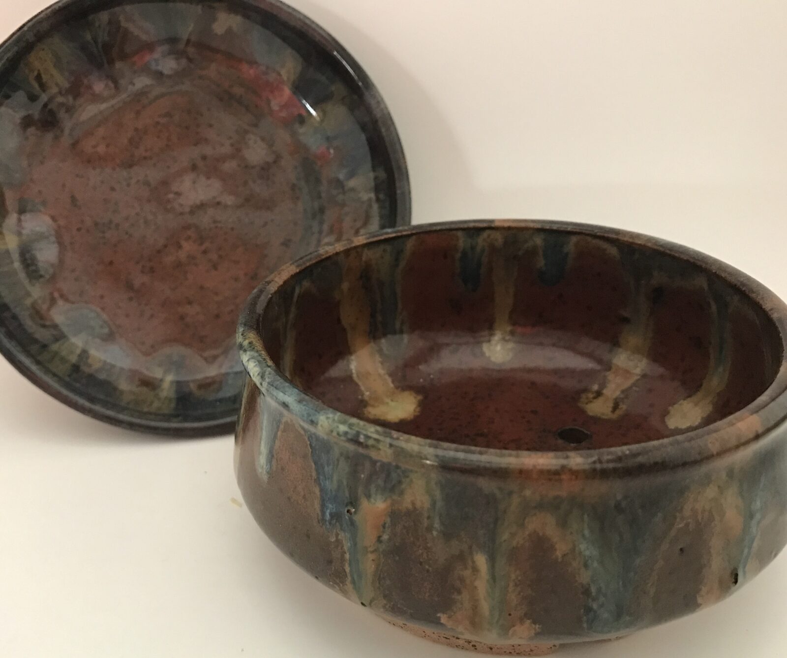 Bowl and matching plate with rich brown and blue drip glaze